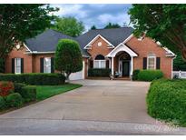 Charming brick home boasts a well-manicured lawn, mature trees, and a long driveway to the garage and front entrance at 2289 Veery Ln # 23, Rock Hill, SC 29732
