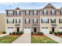 Charming townhome with well-manicured lawn, attached garages, and traditional architectural details at 2635 Mccurdy Trl, Charlotte, NC 28269