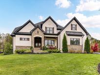 Beautiful home showcasing a manicured front lawn and stone accents on the facade at 2954 Holbrook Rd, Fort Mill, SC 29715