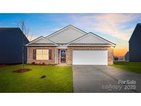 Charming brick home featuring an attached two-car garage, well-maintained lawn, and inviting front entrance at 3662 Charles Nw St, Conover, NC 28613