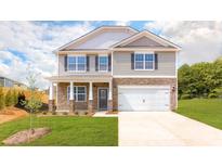 Charming two-story home featuring stone accents, a two-car garage, and a well-manicured lawn at 3948 Ashton Nw Dr, Conover, NC 28613