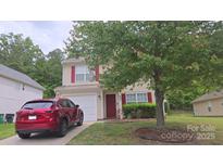 Charming two-story home with a well-maintained lawn and a red Mazda parked in the driveway at 632 Pawley Dr, Charlotte, NC 28214