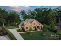 Beautiful brick home featuring lush landscaping and mature trees enhancing its curb appeal at 67 41St Nw Ave # 3, Hickory, NC 28601