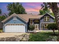 Charming two-story home with a two-car garage, landscaped yard, and inviting front entrance at 7218 Jacobs Fork Ln, Charlotte, NC 28273