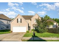 Charming, well-maintained two-story home featuring a two-car garage and beautifully landscaped front yard at 8414 Oak Ne Dr, Charlotte, NC 28269