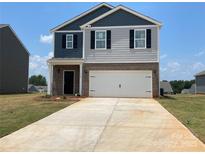 Two-story home featuring a mix of gray siding and brick, a two-car garage, and a concrete driveway at 156 Parker Claire Ln, Kings Mountain, NC 28086