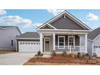 Charming single-Gathering home boasting a covered porch, gray siding, and a well-manicured lawn at 2031 Skyhawk Dr, York, SC 29745