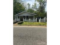 Charming bungalow-style house with a cozy front porch and white picket fence at 216 Maple St, Statesville, NC 28677