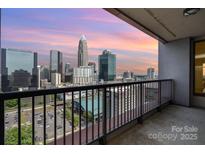 Relax on this balcony with stunning city skyline views and black metal railings at 222 S Caldwell St # 1909, Charlotte, NC 28202