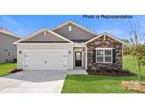 Charming single-story home with a two-car garage, stone accents and a well-manicured lawn at 249 Giant Oak Ave, Statesville, NC 28677