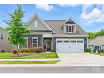 Charming home featuring a manicured lawn, colorful landscaping, and a two-car garage at 4069 Havenport Cir, Fort Mill, SC 29708