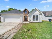 Charming one-story home featuring an attached two-car garage and a well-maintained front lawn at 4101 New Castle Ln, Monroe, NC 28110