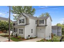 Charming two-story home with light gray siding, black shutters, and a one-car garage with driveway at 414 King St, Waxhaw, NC 28173