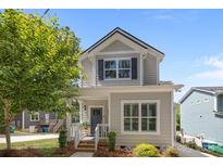 Charming two-story home featuring a welcoming front porch and well-maintained landscaping at 414 King St, Waxhaw, NC 28173