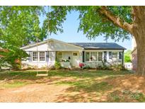 Charming single-story home with a well-maintained front yard and mature trees at 4838 Holbrook Dr, Charlotte, NC 28212