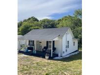 Charming exterior of a bright white one story home with a cozy front porch and well manicured yard at 642 Boger St, Mooresville, NC 28115