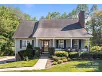 Charming single-story home with a landscaped front yard, inviting porch, and classic architectural details at 1002 4Th Ne St, Conover, NC 28613