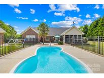 Backyard pool area with lovely, well-maintained pool, patio and a privacy fence at 1305 Glenview Ln, Rock Hill, SC 29730