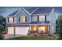 Charming two-story home boasts a stone-accented facade, inviting entry, and a convenient three-car garage at 137 Apple Orchard Ct, Statesville, NC 28677