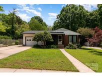 Charming single-story home with well-maintained lawn, mature trees, and attached garage at 1509 Wiltshire Rd, Salisbury, NC 21844