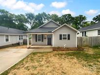 Charming single story home featuring black shutters, covered front porch, and freshly mulched flower beds at 652 Wilson St, Kannapolis, NC 28083