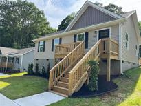 Charming home with a welcoming wooden staircase and lovely landscaping enhancing the curb appeal at 953 Hardin Dr, Shelby, NC 28150