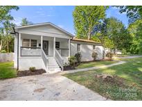 Charming white brick home with a welcoming front porch and well-maintained landscaping at 104 Berry St, Fort Mill, SC 29715