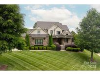 Stunning two-story home with manicured lawn and mature trees, perfect for curb appeal at 11000 Strike The Gold Ln, Waxhaw, NC 28173