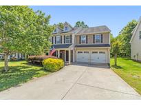 Charming two-story home with a well-manicured lawn and two-car garage at 111 Tilton Dr, Mooresville, NC 28115