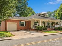Charming bungalow with a brick facade and a cozy front porch, perfect for enjoying the outdoors at 170 8Th Ave, Cramerton, NC 28032