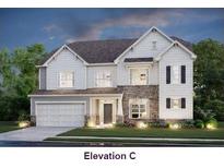 Charming two-story home featuring a stone facade, attached garage, and beautifully landscaped front yard at 215 Hogan'S Valley Way, Salisbury, NC 28144