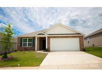 Charming brick home features a well-maintained lawn, attached garage, and inviting entryway at 2554 Goose Fair Rd, Maiden, NC 28650