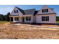 Charming new construction home with a covered porch and classic black shutters against a bright white exterior at 4648 Simpson Rd, Edgemoor, SC 29712