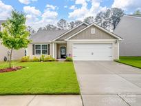 Charming single-story home featuring a well-manicured lawn, two-car garage, and inviting curb appeal at 584 Lamorak Pl, Richburg, SC 29729
