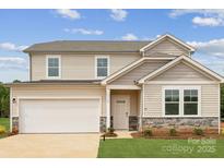 Charming two-story home featuring stone accents, a two-car garage, and a well-maintained lawn at 1117 Hallman Branch Ln, Lincolnton, NC 28092