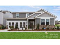 Charming two-story home showcasing a manicured lawn, stone accents, and a welcoming front entrance at 1117 Hallman Branch Ln, Lincolnton, NC 28092