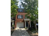 Charming brick townhome with a one-car garage and well-maintained landscaping at 1295 Amber Ridge Nw Rd, Concord, NC 28027