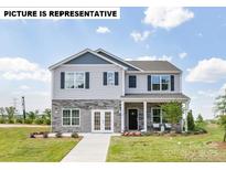 Charming two-story home with stone accents and a welcoming front porch perfect for enjoying the outdoors at 135 Calvin Creek Dr, Troutman, NC 28166