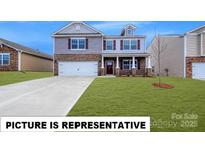 Charming two-story home showcasing a well-manicured lawn and a classic brick and siding exterior at 143 Way Cross Ln, Troutman, NC 28166