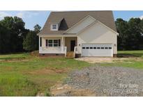 Charming home featuring light siding, a covered porch, and an attached garage with ample parking space at 144 Mason Tanner Ct, Rock Hill, SC 29730