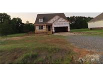 New construction home featuring a two-car garage, front porch and unfinished lawn at 144 Mason Tanner Ct, Rock Hill, SC 29730