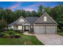 Charming craftsman home with a landscaped front yard and two-car garage offers great curb appeal at 2646 Lee Lawing Rd, Lincolnton, NC 28092
