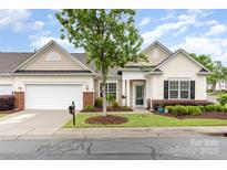 Charming single-story home featuring a well-manicured lawn and inviting front porch, perfect for relaxing at 31470 Royal Tern Ln, Indian Land, SC 29707