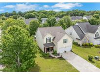 Charming two-story home featuring a well-manicured lawn, lush landscaping, and a two-car garage at 544 Cool Creek Dr, Rock Hill, SC 29732