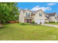 Charming two-story home featuring a well-manicured lawn, lush landscaping, and a welcoming front porch at 544 Cool Creek Dr, Rock Hill, SC 29732