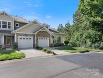 Charming townhome featuring a stone facade, two-car garage, and well-maintained landscaping at 1219 Crown Vista Dr, Fort Mill, SC 29707