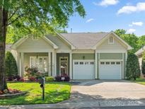 Charming home with a well-manicured lawn, a two-car garage, and beautiful landscaping at 3068 Streamhaven Dr, Lancaster, SC 29707