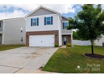 Charming two-story home with a two-car garage, brick accents, and manicured lawn at 316 Gaines Rd, Clover, SC 29710