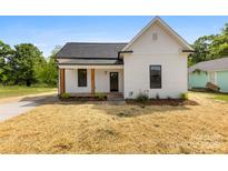 Charming renovated home with a well-maintained front yard, and inviting porch at 317 S Pink St, Cherryville, NC 28021