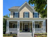 Charming two-story home featuring a welcoming front porch, black shutters, and manicured landscaping at 3426 Richards Xing, Fort Mill, SC 29708